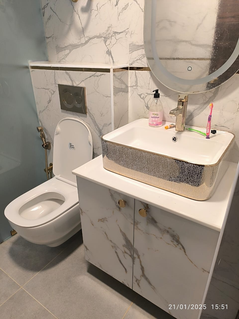 Bathroom with gold fittings and marble sink