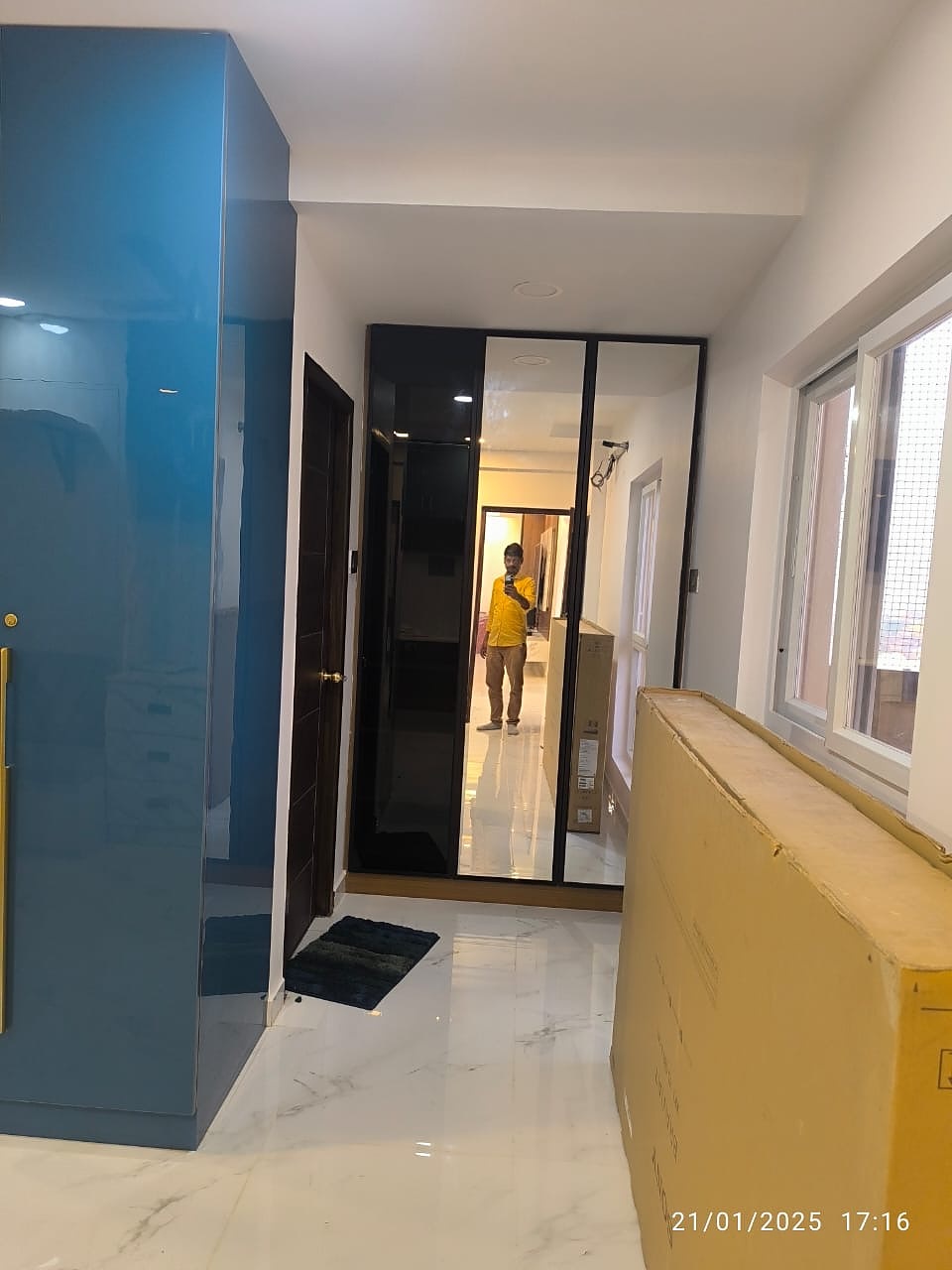Corridor with blue wardrobe and mirror