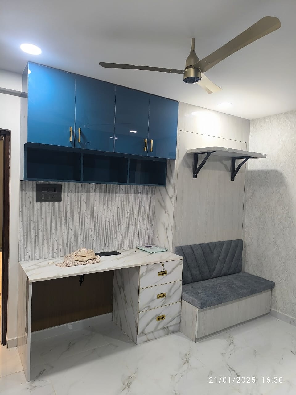 Study nook with blue overhead cabinet