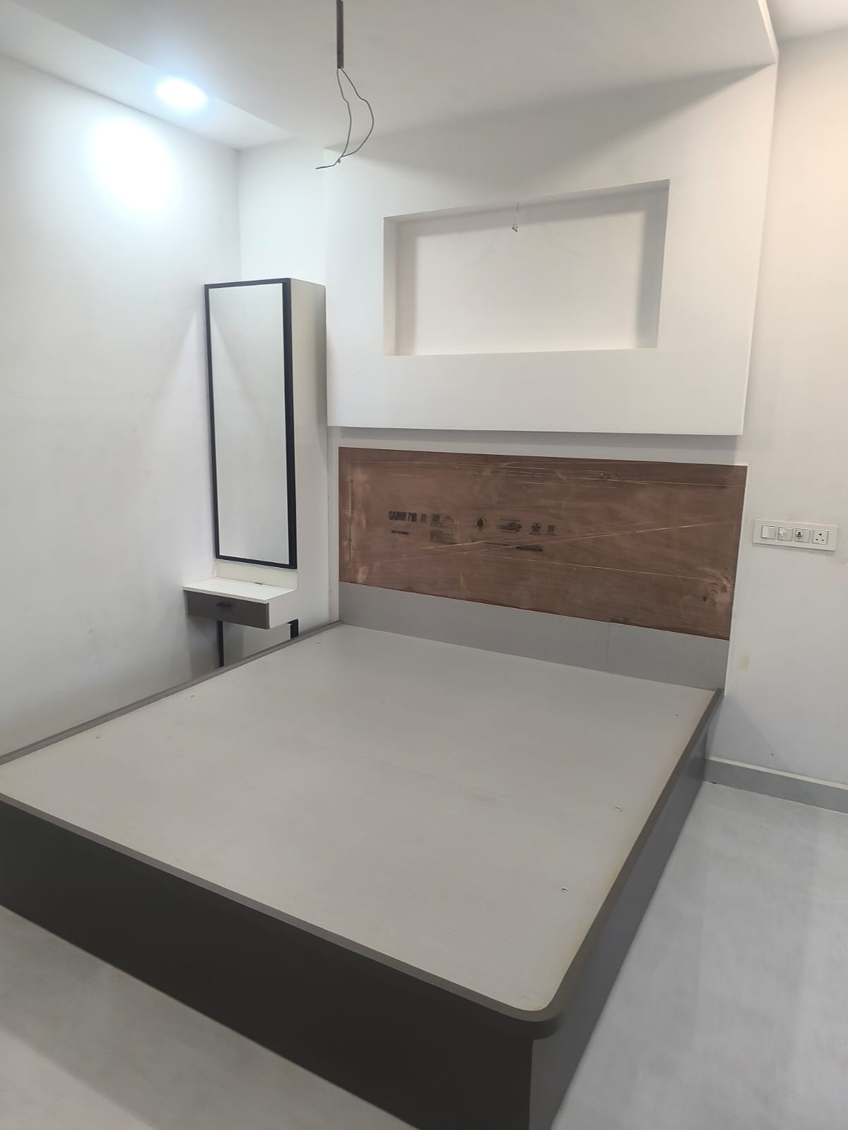 Bedroom with bed and mirror dresser